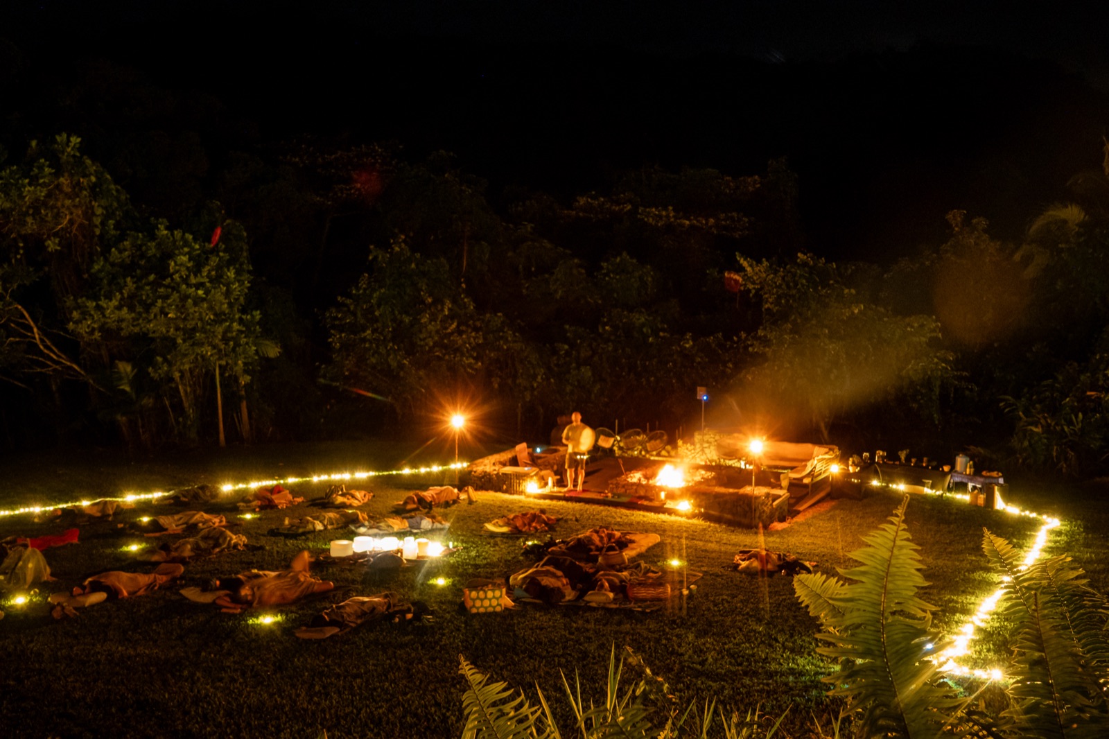 The whole space at night, the circle resting as the fire glows