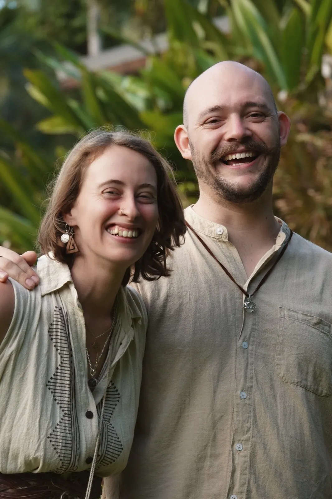 Sammy and Jordy smiling together in the rainforest.